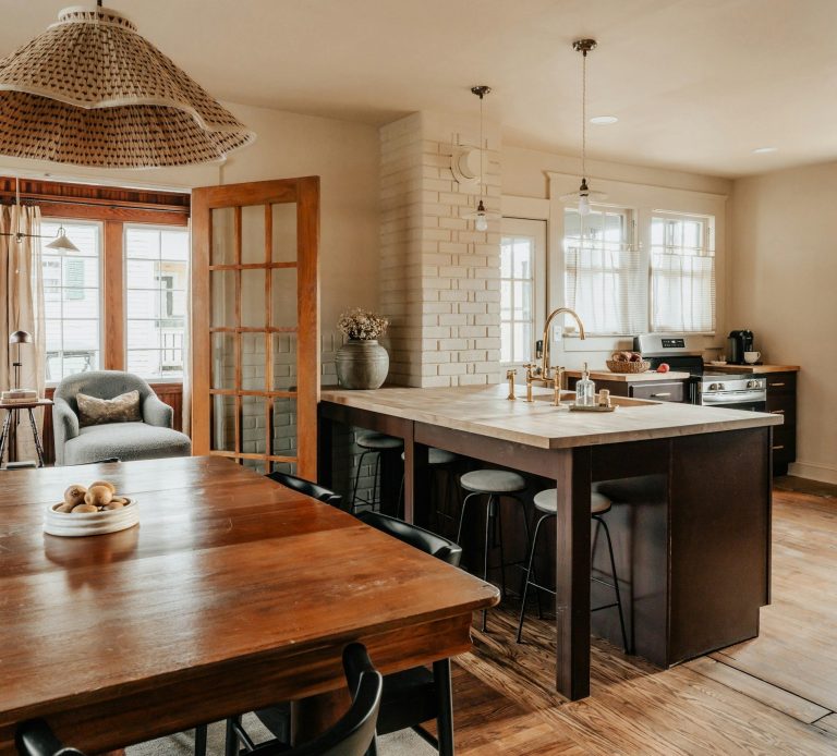 Painted kitchen island with seating underneath in a well lit room